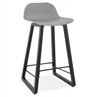 Black bar stool with solid seat and wooden leg with practical footrest